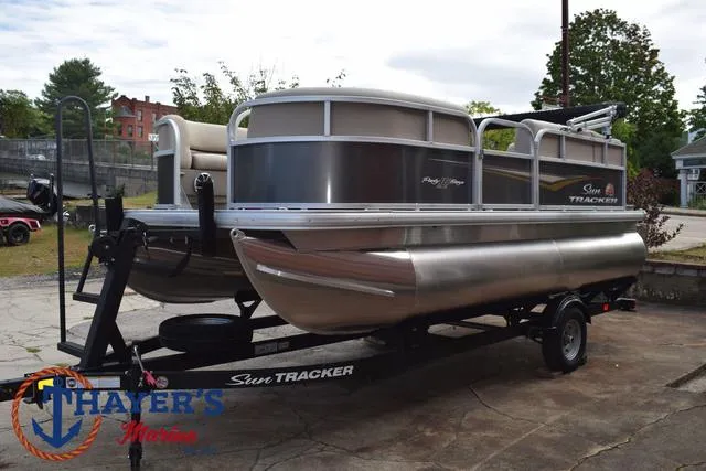 Slide: The Image of 2025 Sun Tracker PARTY BARGE® 16 DLX pontoon boat on trailer, outdoor setting. - 8