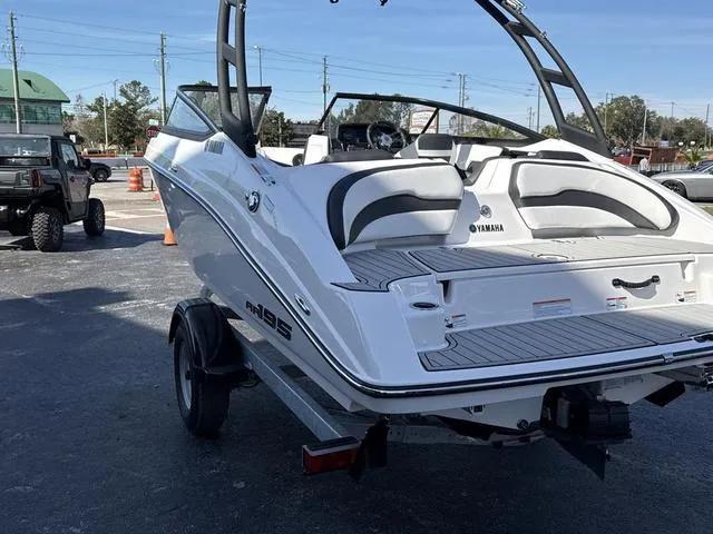 Slide: The Image of 2025 Yamaha AR195 boat interior, white and gray seating, sleek design. - 11