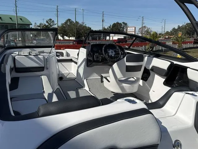 Slide: The Image of 2025 Yamaha AR195 boat interior, white and gray seating, sleek design. - 13