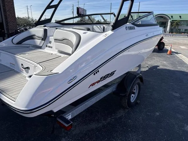 Slide: The Image of 2025 Yamaha AR195 boat interior, white and black seating, modern design. - 4