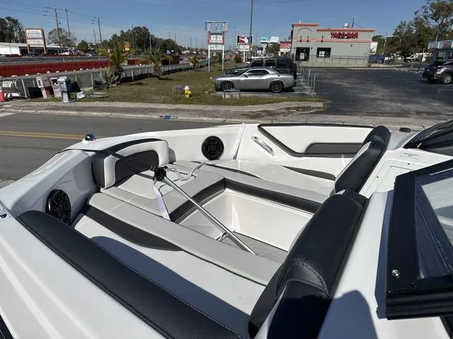 Slide: The Image of 2025 Yamaha AR195 boat interior with sleek white and black seating design. - 5