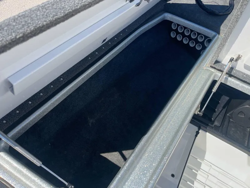 Slide: The Image of 2015 Phoenix 819 Pro boat storage compartment with rod holders. - 18