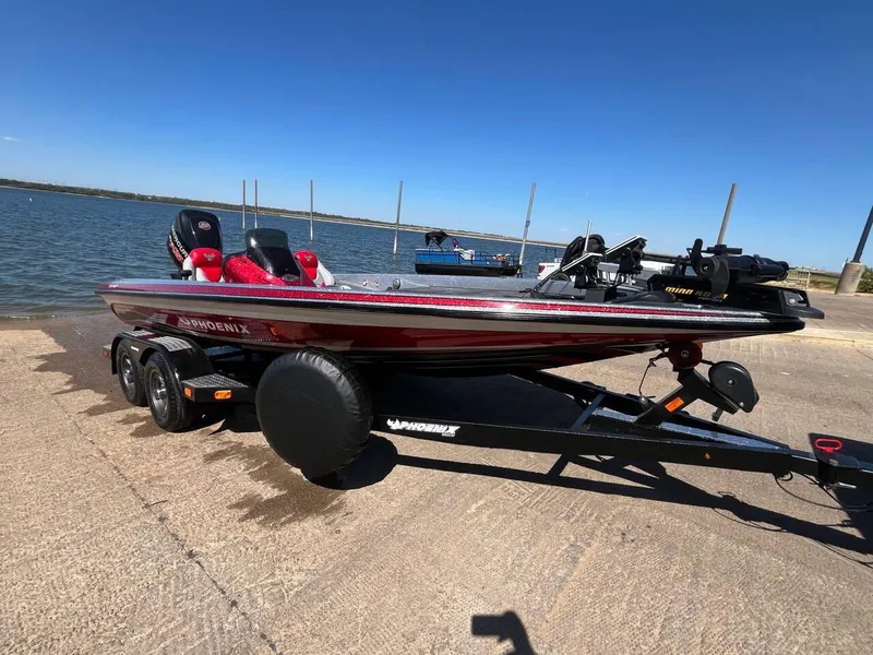 Slide: The Image of 2015 Phoenix 819 Pro boat on trailer by the water, ready for launch. - 2