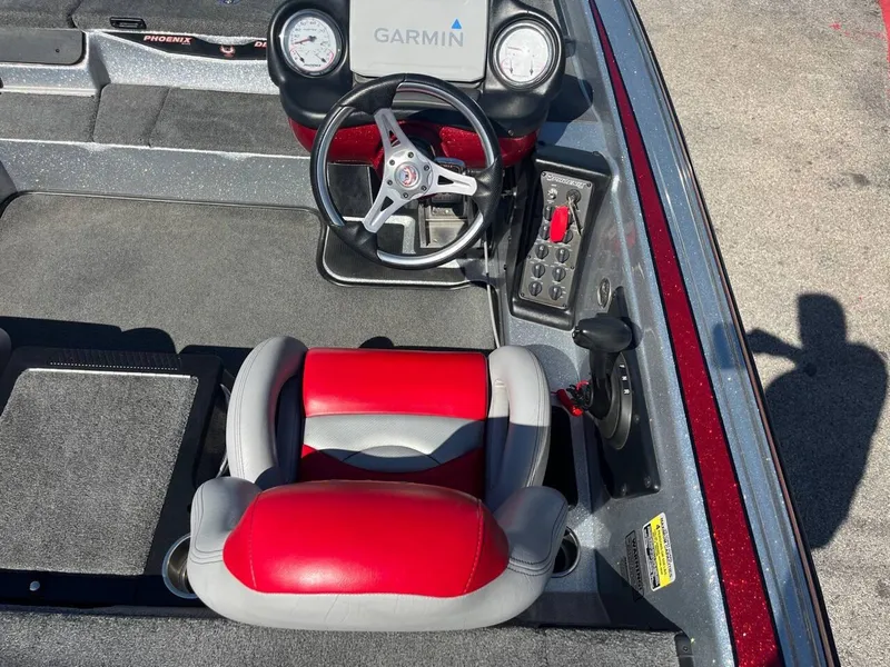Slide: The Image of 2015 Phoenix 819 Pro boat cockpit with Garmin GPS and red-gray seating. - 27
