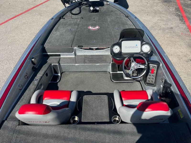 Slide: The Image of 2015 Phoenix 819 Pro boat interior with red seats and Garmin navigation system. - 28