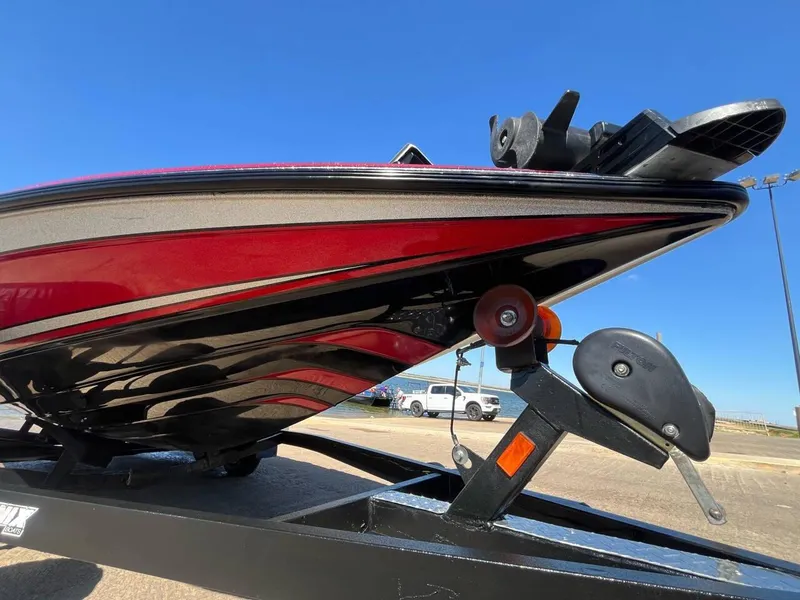 Slide: The Image of 2015 Phoenix 819 Pro boat on trailer, red and black design, clear blue sky background. - 32