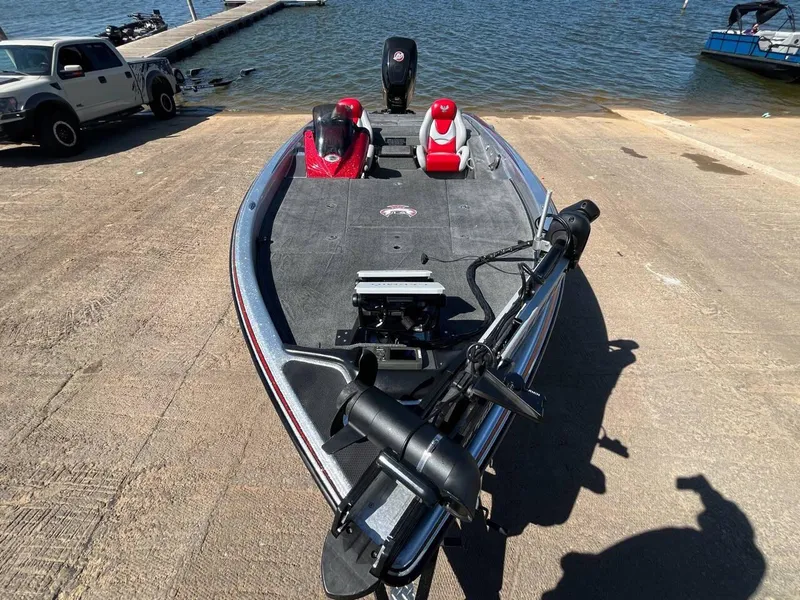 Slide: The Image of 2015 Phoenix 819 Pro boat on ramp by lake, featuring red and gray seating. - 35