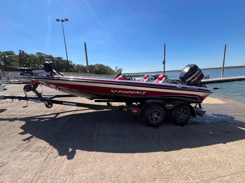 Slide: The Image of 2015 Phoenix 819 Pro boat on trailer by a lake under clear blue sky. - 42