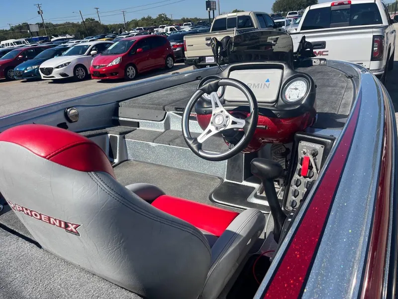 Slide: The Image of 2015 Phoenix 819 Pro boat interior with steering wheel and Garmin display. - 44