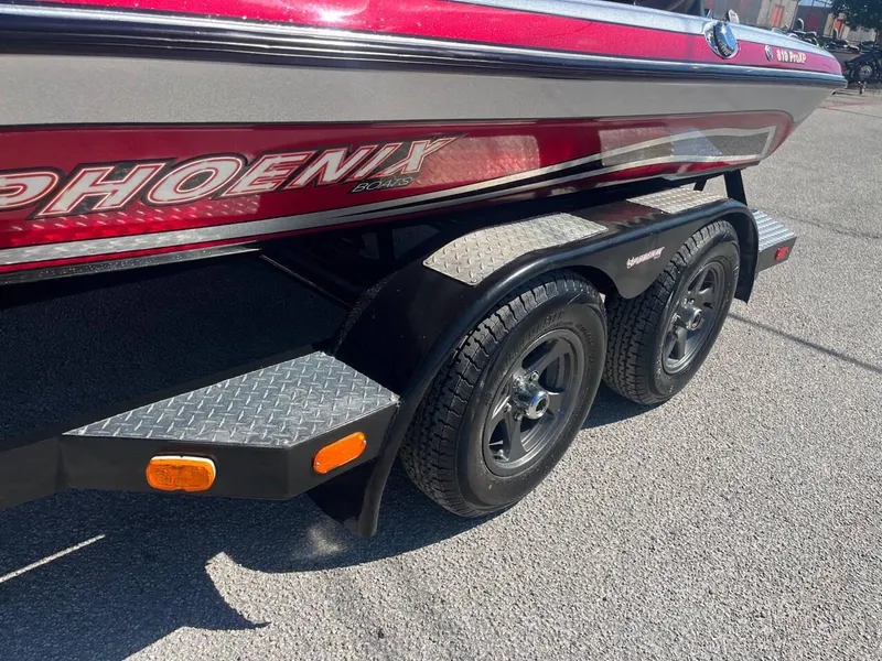 Slide: The Image of 2015 Phoenix 819 Pro boat trailer with dual axles and red accents. - 48