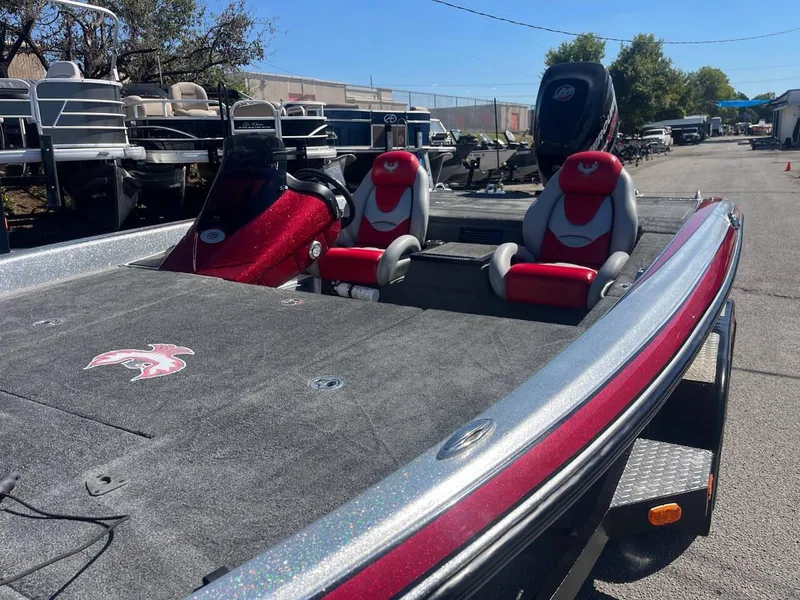Slide: The Image of 2015 Phoenix 819 Pro boat with red and gray seating, parked outdoors. - 49