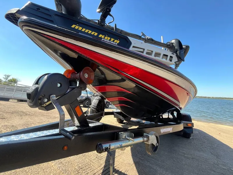 Slide: The Image of 2015 Phoenix 819 Pro boat on trailer by lake, featuring Minn Kota motor. - 6