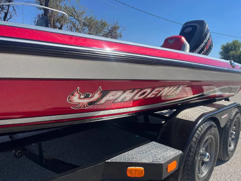 Slide: The Image of 2015 Phoenix 819 Pro boat with red and silver detailing on a trailer. - 7