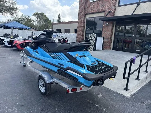Slide: The Image of 2025 Yamaha Marine Waverunner FX SVHO in black and cyan, side view. - 3