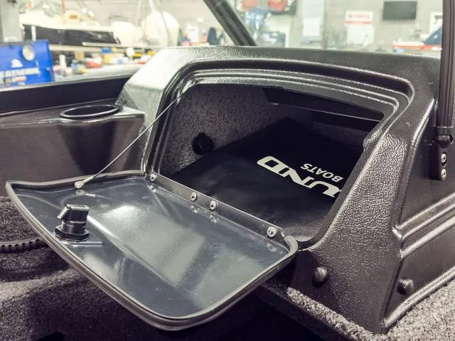 Slide: The Image of 2025 Lund 1775 Adventure Sport boat glove compartment open, showcasing interior storage space. - 13