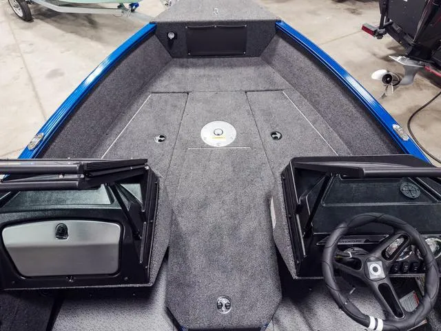 Slide: The Image of 2025 Lund 1775 Adventure Sport boat interior with steering wheel and carpeted deck. - 14