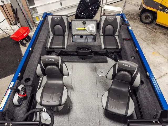 Slide: The Image of 2025 Lund 1775 Adventure Sport boat interior with four seats in a workshop setting. - 3