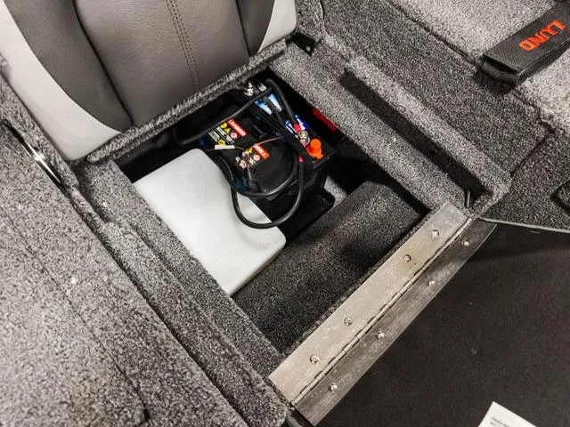 Slide: The Image of 2025 Lund 1775 Adventure Sport boat battery compartment with wiring and storage. - 5
