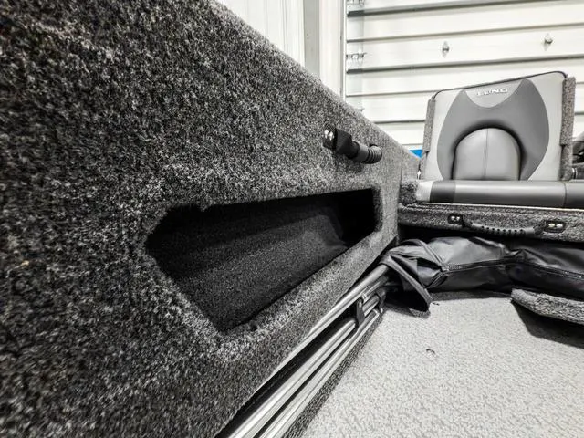 Slide: The Image of 2025 Lund 1775 Adventure Sport interior with storage compartment and seating. - 7