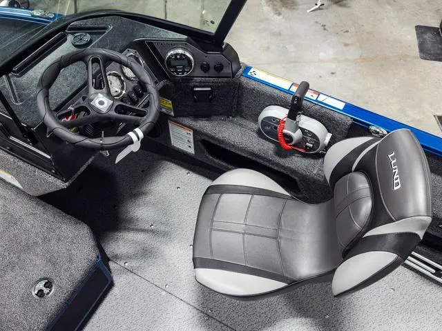 Slide: The Image of 2025 Lund 1775 Adventure Sport boat interior with steering wheel and seat. - 9