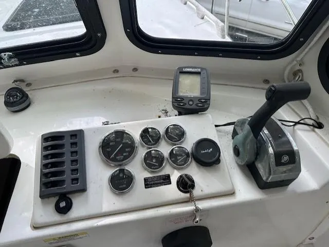 Slide: The Image of 2007 Eastern Pilothouse dashboard with gauges, controls, and Lowrance navigation system. - 6