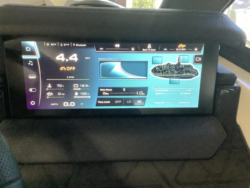 Slide: The Image of 2025 Nautique GS22 dashboard display showing speed, depth, and wake settings. - 12