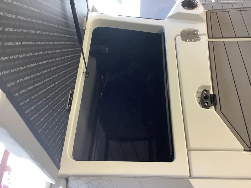 Slide: The Image of 2025 Nautique GS22 storage compartment with sleek design and durable materials. - 15
