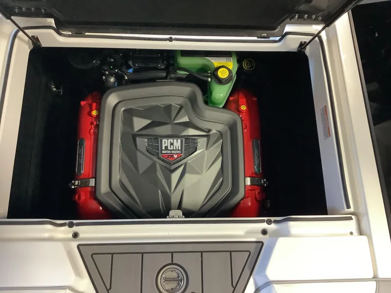 Slide: The Image of 2025 Nautique GS22 PCM engine compartment with red and gray components. - 17