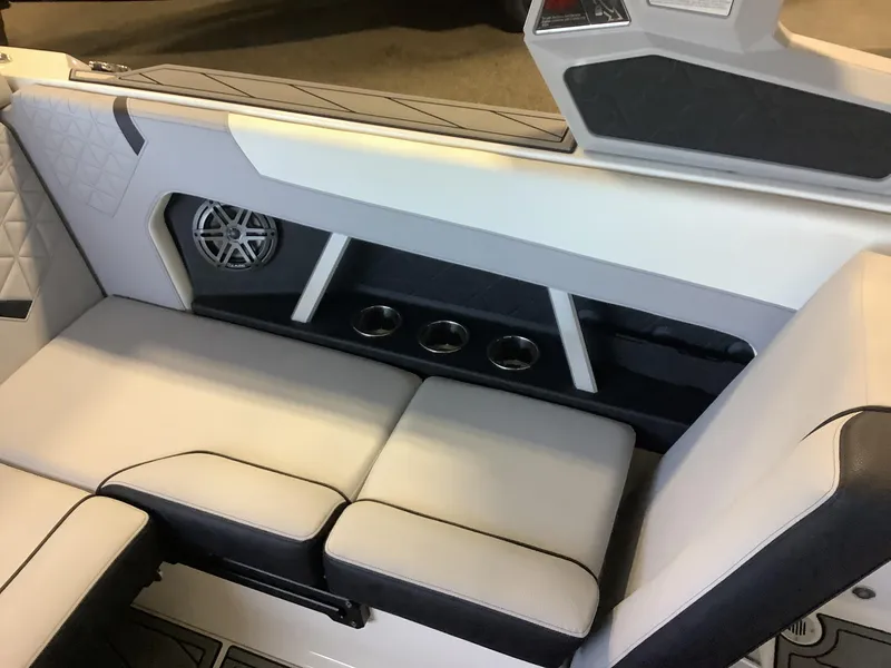 Slide: The Image of 2025 Nautique GS22 interior seating with speaker and cup holders. - 18