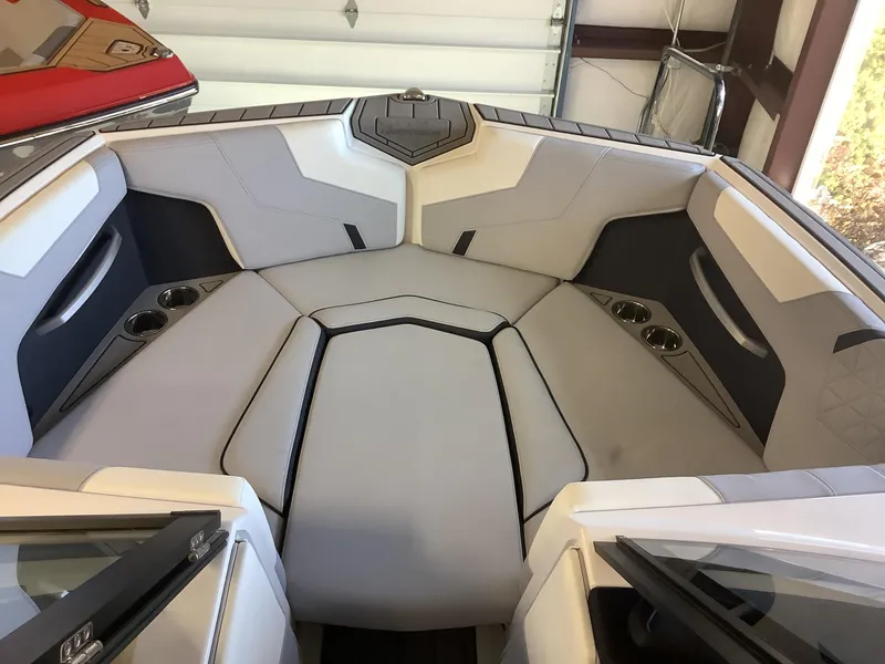 Slide: The Image of 2025 Nautique GS22 boat interior with sleek seating and cup holders. - 6