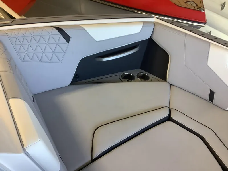 Slide: The Image of 2025 Nautique GS22 interior seating with cup holders and modern design. - 8