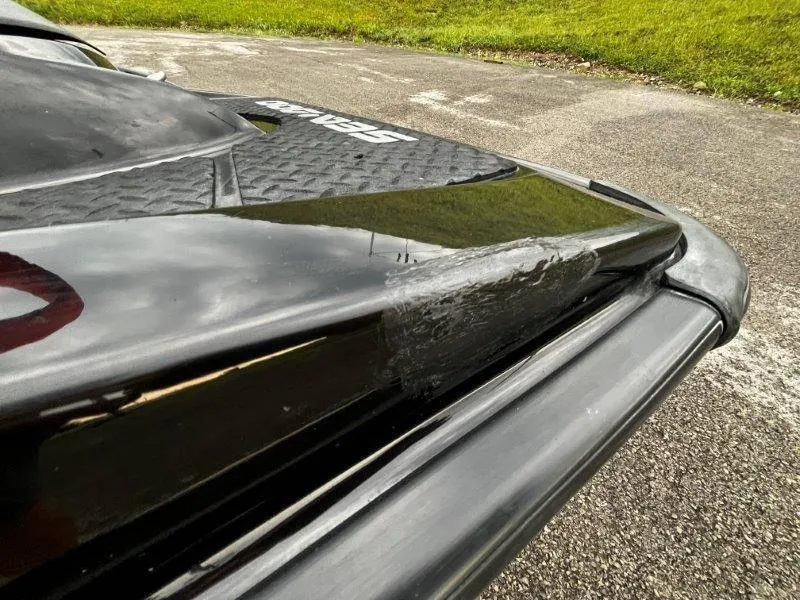 Slide: The Image of Close-up of 2011 Sea-Doo RXP 255 jet ski with visible surface damage. - 30