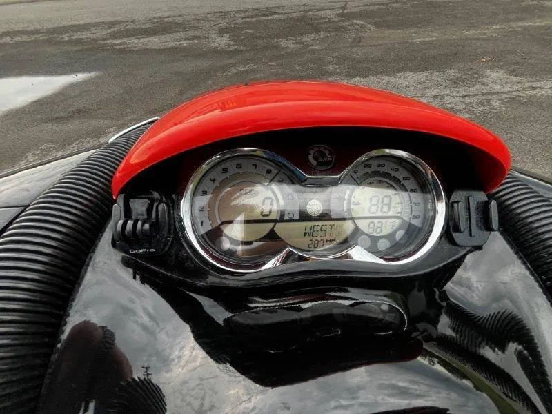Slide: The Image of Close-up of 2011 Sea-Doo RXP 255 dashboard with red cover and digital display. - 4