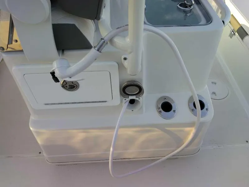 Slide: The Image of 2024 Ranger 2510 Bay boat console with rod holders and storage compartments. - 11