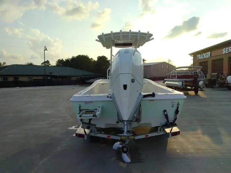 Slide: The Image of 2024 Ranger 2510 Bay boat on trailer at sunset, rear view. - 3