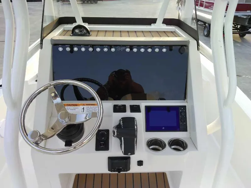 Slide: The Image of 2024 Ranger 2510 Bay boat console with steering wheel and navigation controls. - 5