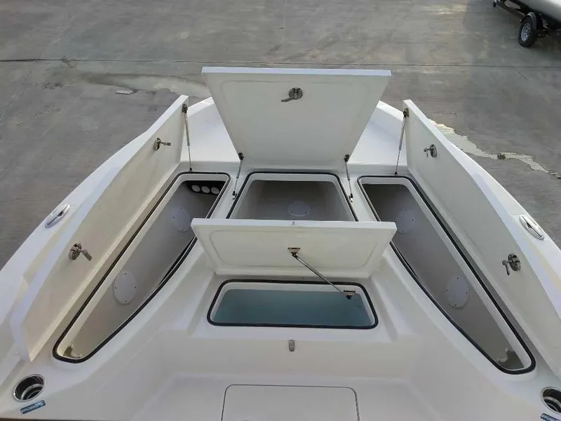 Slide: The Image of 2024 Ranger 2510 Bay boat with open storage compartments on deck. - 7