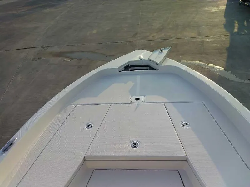 Slide: The Image of 2024 Ranger 2510 Bay boat deck, featuring storage compartments and anchor. - 8
