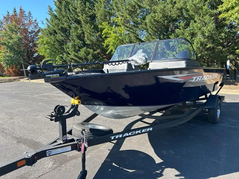 Slide: The Image of 2025 Tracker Pro Guide V-175 Combo boat on trailer, parked outdoors. - 3