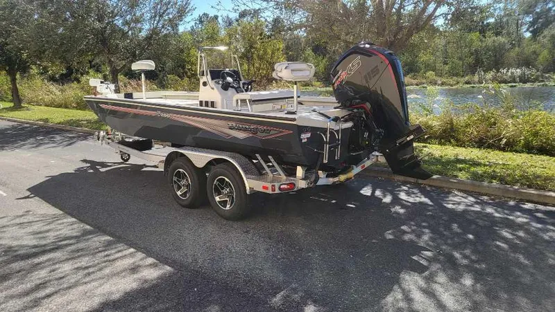 Slide: The Image of 2024 Ranger RB200 boat on trailer, parked near a scenic lake. - 5