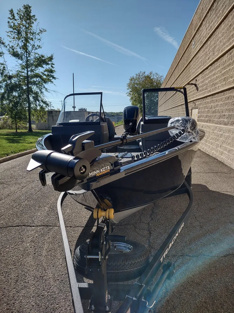 Slide: The Image of 2025 Tracker Pro Guide V-175 WT boat on trailer, parked outdoors. - 4