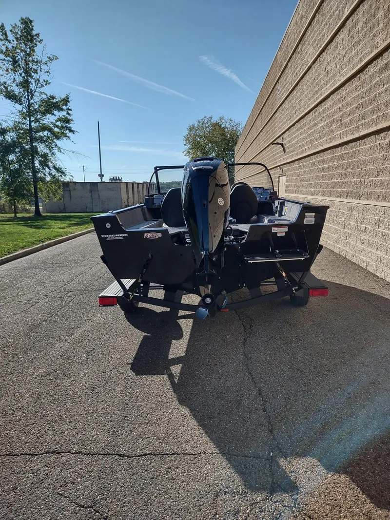 Slide: The Image of 2025 Tracker Pro Guide V-175 WT boat parked outdoors on a sunny day. - 5