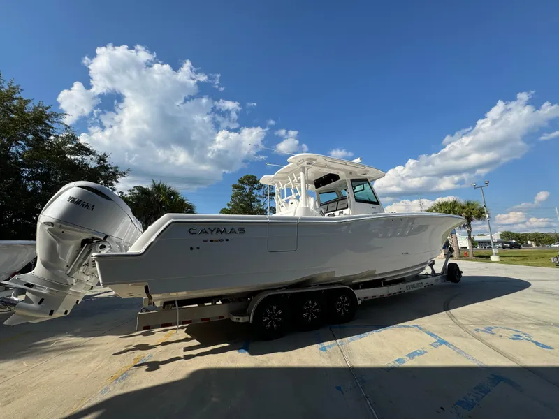 Slide: The Image of 2025 Caymas 401 CC boat on trailer under blue sky. - 14