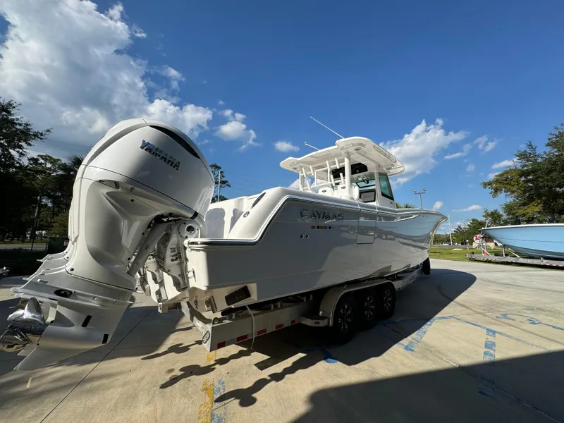 Slide: The Image of 2025 Caymas 401 CC boat with Yamaha engines, parked outdoors under a clear blue sky. - 15