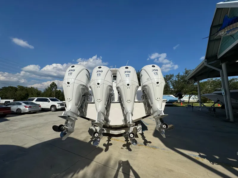 Slide: The Image of 2025 Caymas 401 CC boat with four powerful outboard engines in a sunny outdoor setting. - 17