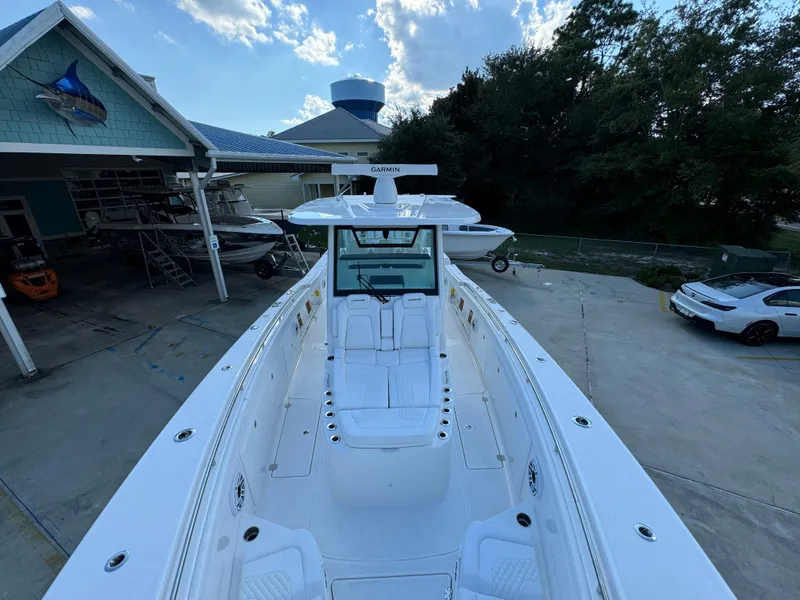 Slide: The Image of 2025 Caymas 401 CC boat docked at a marina under a blue sky. - 23