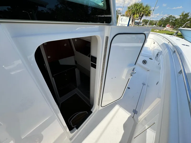 Slide: The Image of 2025 Caymas 401 CC boat cabin entrance with open door, showcasing interior space. - 27