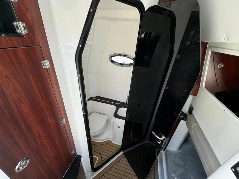 Slide: The Image of 2025 Caymas 401 CC boat interior with modern bathroom and wood accents. - 30