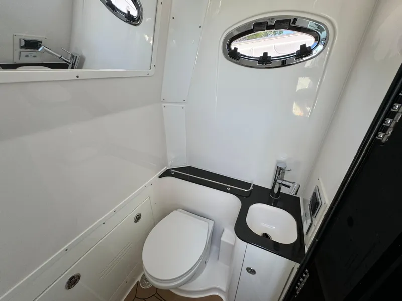 Slide: The Image of 2025 Caymas 401 CC boat bathroom with modern fixtures and oval window. - 31