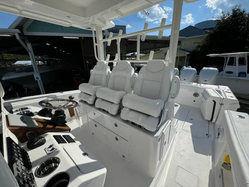 Slide: The Image of 2025 Caymas 401 CC boat interior with white seating and modern controls. - 34